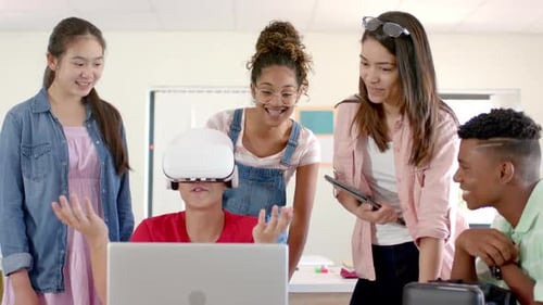 Diverse group of teenagers in high school explores virtual reality, with one wearing a VR headset