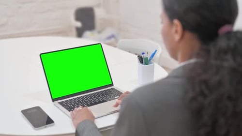 Rare View of African Business Woman Using Laptop with Green Screen