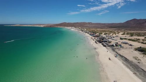 Turquoise Waves Gently Lapping at La Paz Beach's White Sands