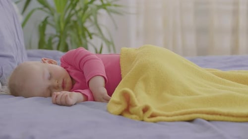 Baby Sleeping Peacefully Under Yellow Blanket