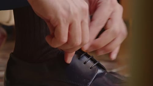 Man Tying Patent Leather Shoes