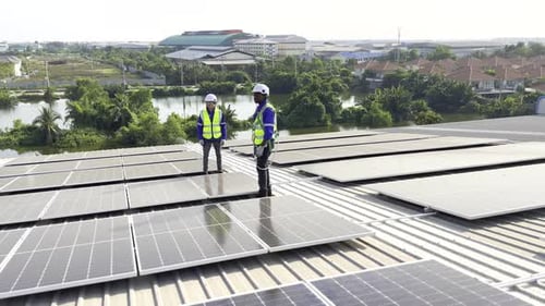 Technician installing solar cell. Installation and maintenance of solar cells on rooftop.