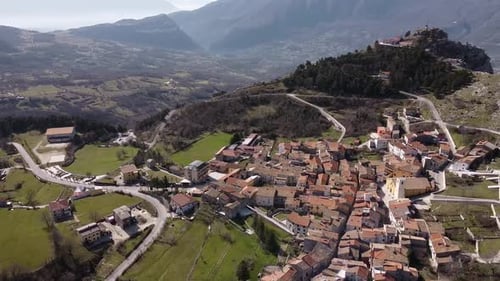 Aerial view above Pietraroja, an italian village on a hill top, on a sunny day