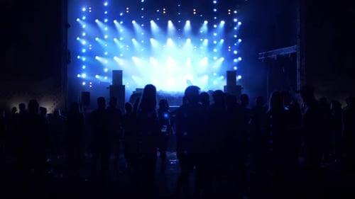 Crowd Enjoying Concert with Bright Blue Lights