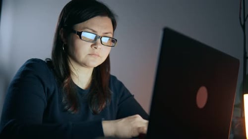 Woman Working Late at Computer at Home