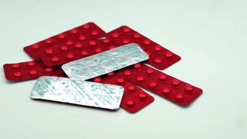 Blister Packs of Red and Silver Medicine Tablets