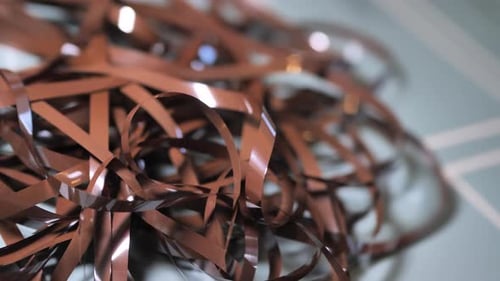 Tape Unreel. Pulling the tape out. Destroying cassette tape media. Zoom in.