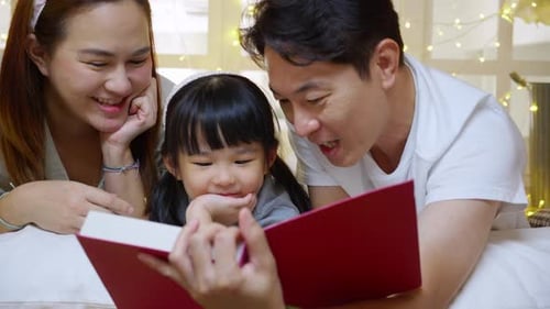 Family Reading Story Book Together Indoors