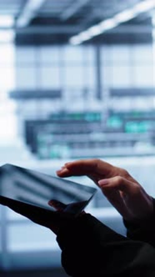 Hand Touching Tablet in Modern Office Building