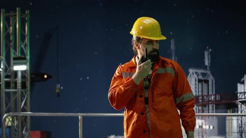 Offshore Platform Engineer Provides Updates Over Walkie Talkie During Oil Crisis