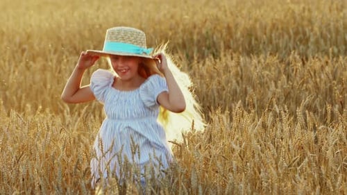Blonde Girl with Long Hair in a Wheat Field