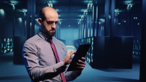 Data Center IT Engineer Standing in Server Room