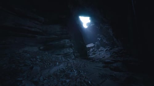 Exploring a Dark Cave with a Bright Light Shining Through the Opening