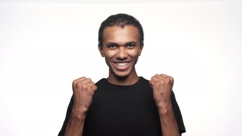 Young Adult Celebrating Against White Background