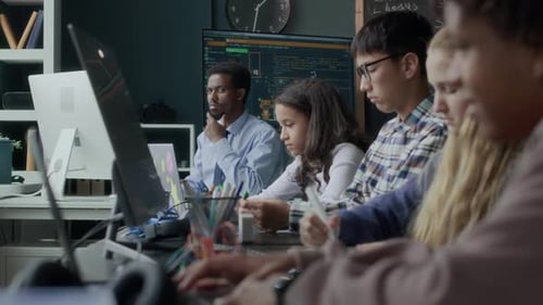 Multiethnic Gen Z Students Having Robotics and Coding Lesson in Class