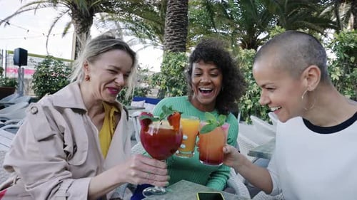 Friends Celebrate with Tropical Cocktails Outdoors
