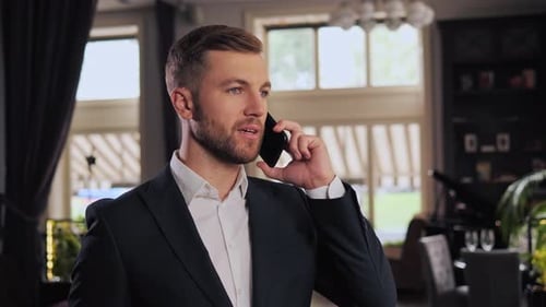 Close Up of Cheerful Businessman Having Phone Call During Business Trip