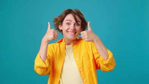 Cheerful Woman Gives Thumbs Up and Points