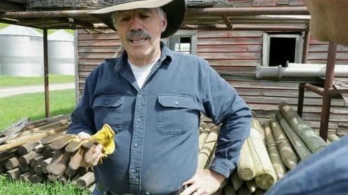 Male Ranchers Talking On Sunny Ranch