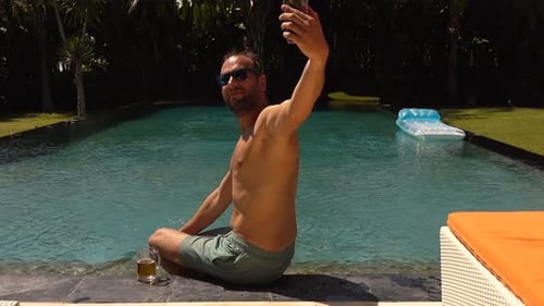 Happy Young Man Selfie by Pool