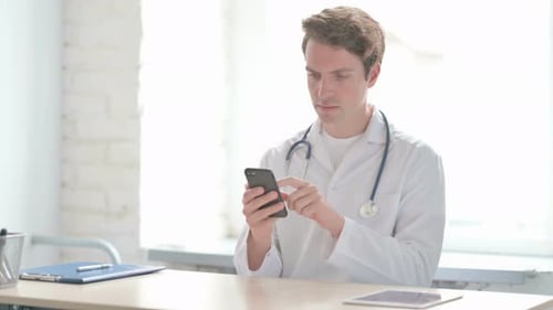 Doctor Using Mobile Phone in Clinic