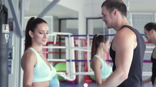 Adults Working Out with Weights at the Gym