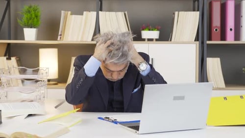 Stressed Man at Desk Reacting to Corporate Deadline