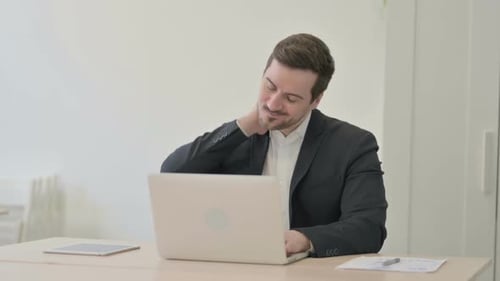Man with Neck Pain Working on Laptop