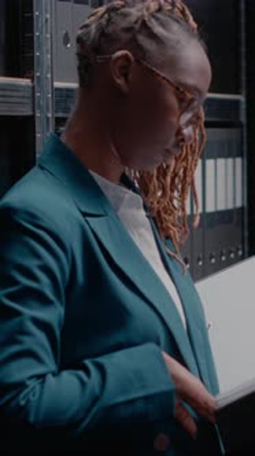 Woman Reads Documents in a Filing Room