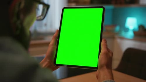 Man Holding Tablet with Green Screen and Tapping