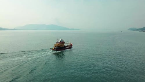Fishing boat returns to Pangkor Island aerial view, Malaysia