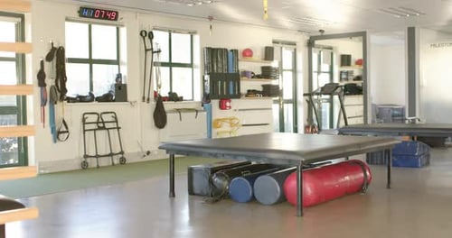 Rehabilitation center gym with equipment for physical therapy and disability rehab, copy space