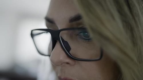 Woman's Eyes Behind Glasses and Reflection of Computer Screen