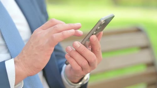 Close up of Businessman Using Smartphone Outdoor