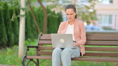Casual Business Woman Shocked by Loss on Laptop Outdoor