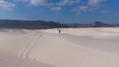 Aerial View of Socotra Island's Desert Landscape Featuring Majestic Sand Dunes and Mountain Backdrop