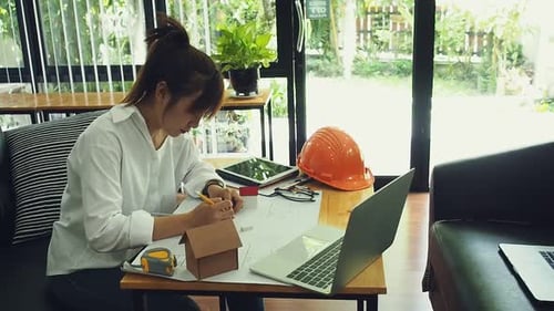 An architect or engineer working on blueprint, architectural concept.