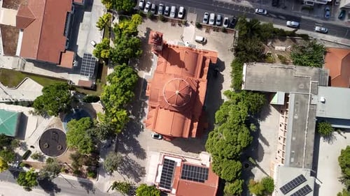 Beautiful aerial view of a historic building surrounded by greenery in a vibrant urban setting