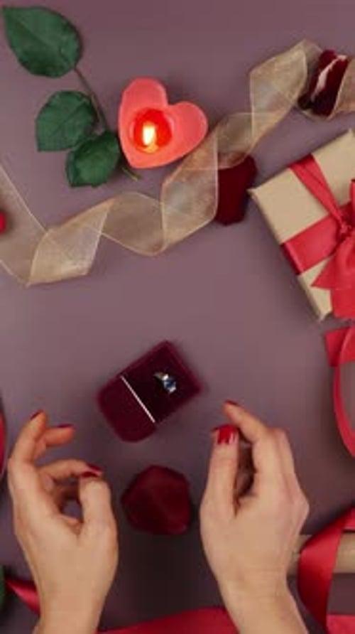 Hands opening box with engagement ring for St. Valentine's Day. Vertical video