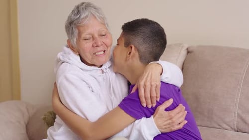 Loving Grandmother Embraces Grandson on Sofa