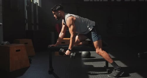 Music, dumbbell and man workout in gym for muscle, wellness and body health