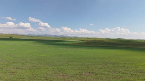 Clouds Passing Over Green Field and Hills
