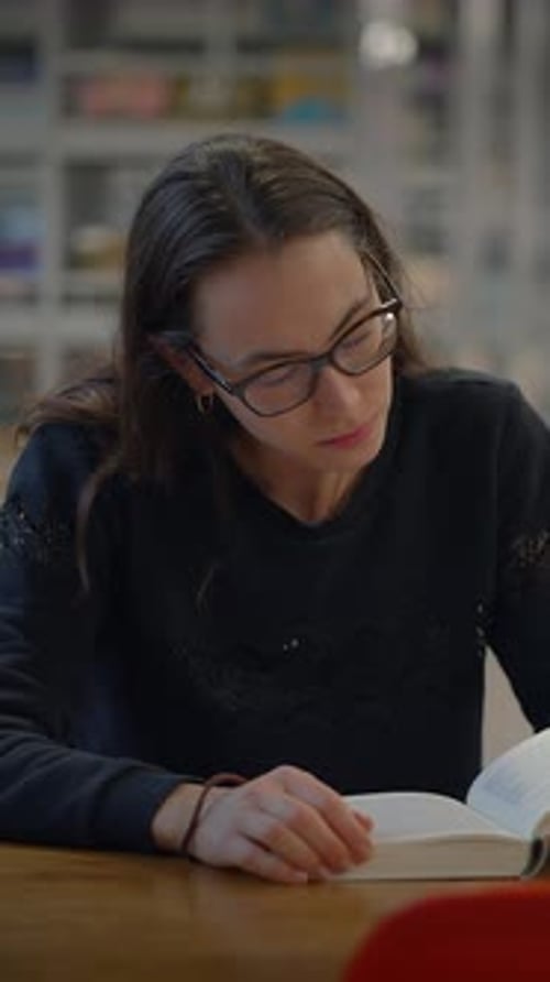 A Focused Young Girl Deeply Engaged in Her Studies Within a Contemporary Library Environment