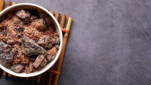 Himalayan Black Salt Rock Crystals Kala Namak in a Container on Table