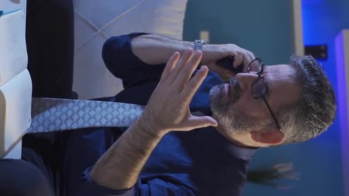Adult Man Talking on Mobile Phone at Desk