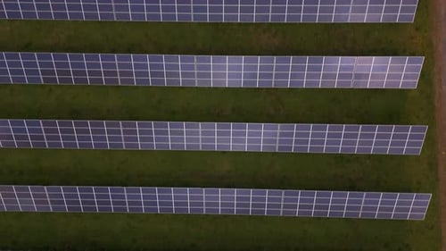 Aerial view of solar panels on green field, United Kingdom.
