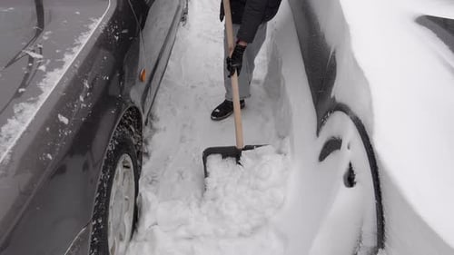 Urban winter chore involving precise snow removal for vehicle access