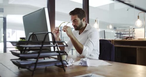 Frustrated, tired and stressed business man working on his pc at the office
