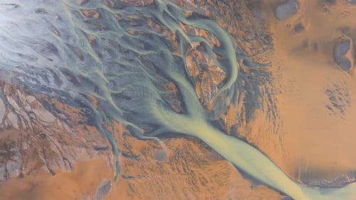 Aerial video over YELLOW RIVER and flowing glaciers in Iceland landscape