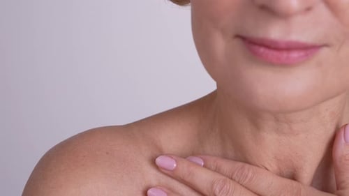 Mature Woman Touching Neck in Close Up